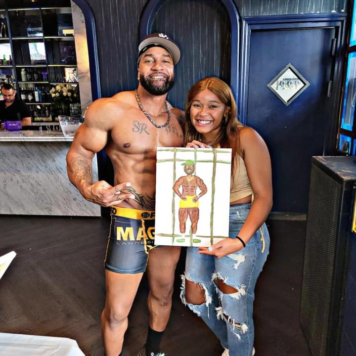 a person standing in front of a group of people posing for the camera